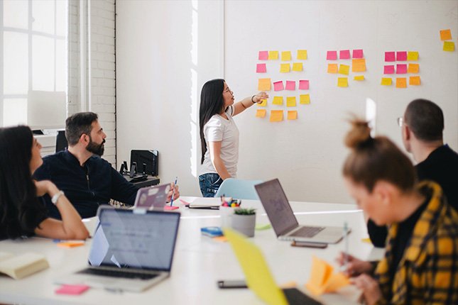 Young woman leads an organisational planning meeting.